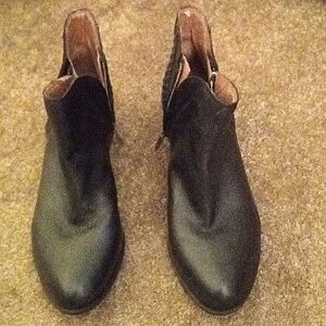 Black ankle boots with design on the heels, side zippers on both sides of boots.